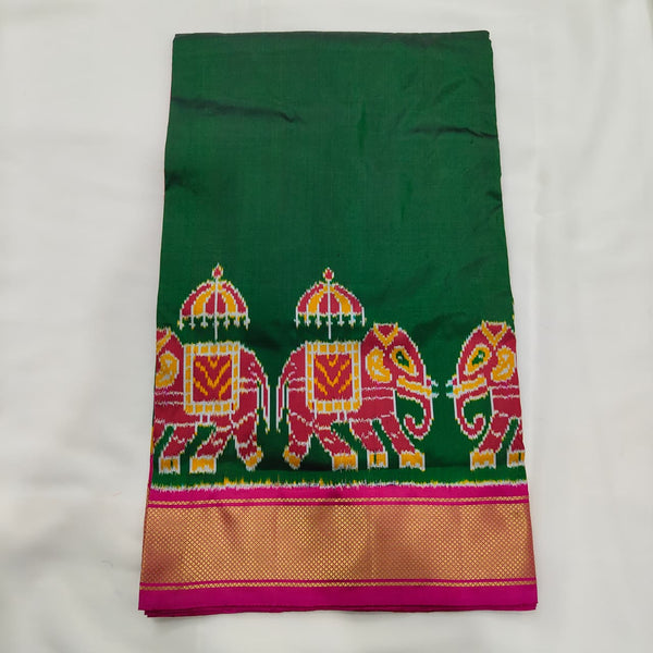 Bottle green ikat silk saree with pink elephant motifs and a pink and gold zari border