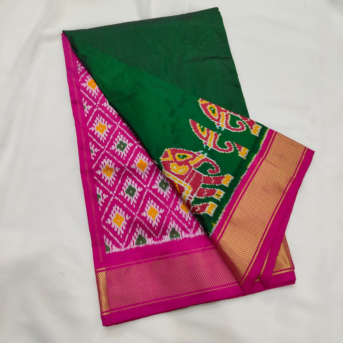 Bottle green ikat silk saree, elephant motif and zari border detail
