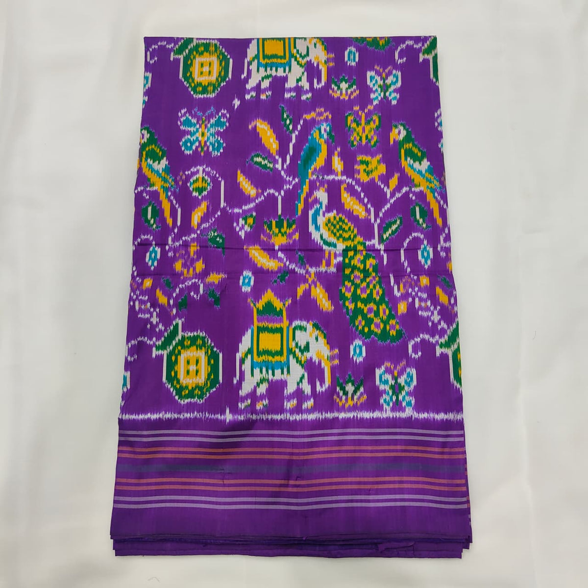 Purple ikat silk saree with elephant, parrot, peacock and butterfly motifs