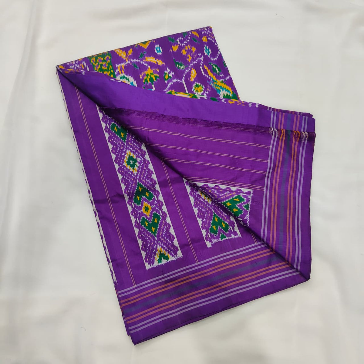 Purple ikat silk saree, motif and striped border detail