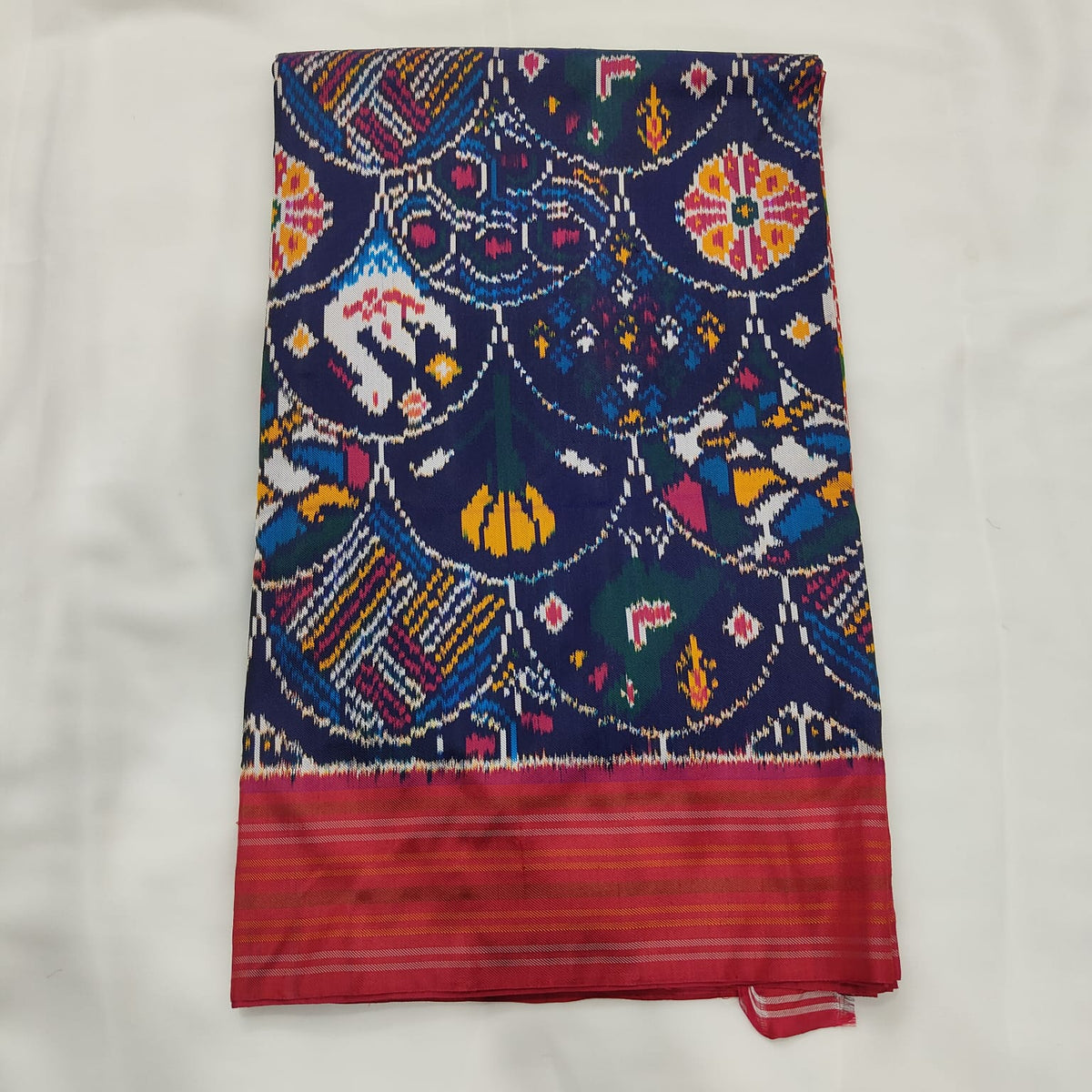 Navy blue Patola ikat silk saree with multicolour motifs and a pink contrast border