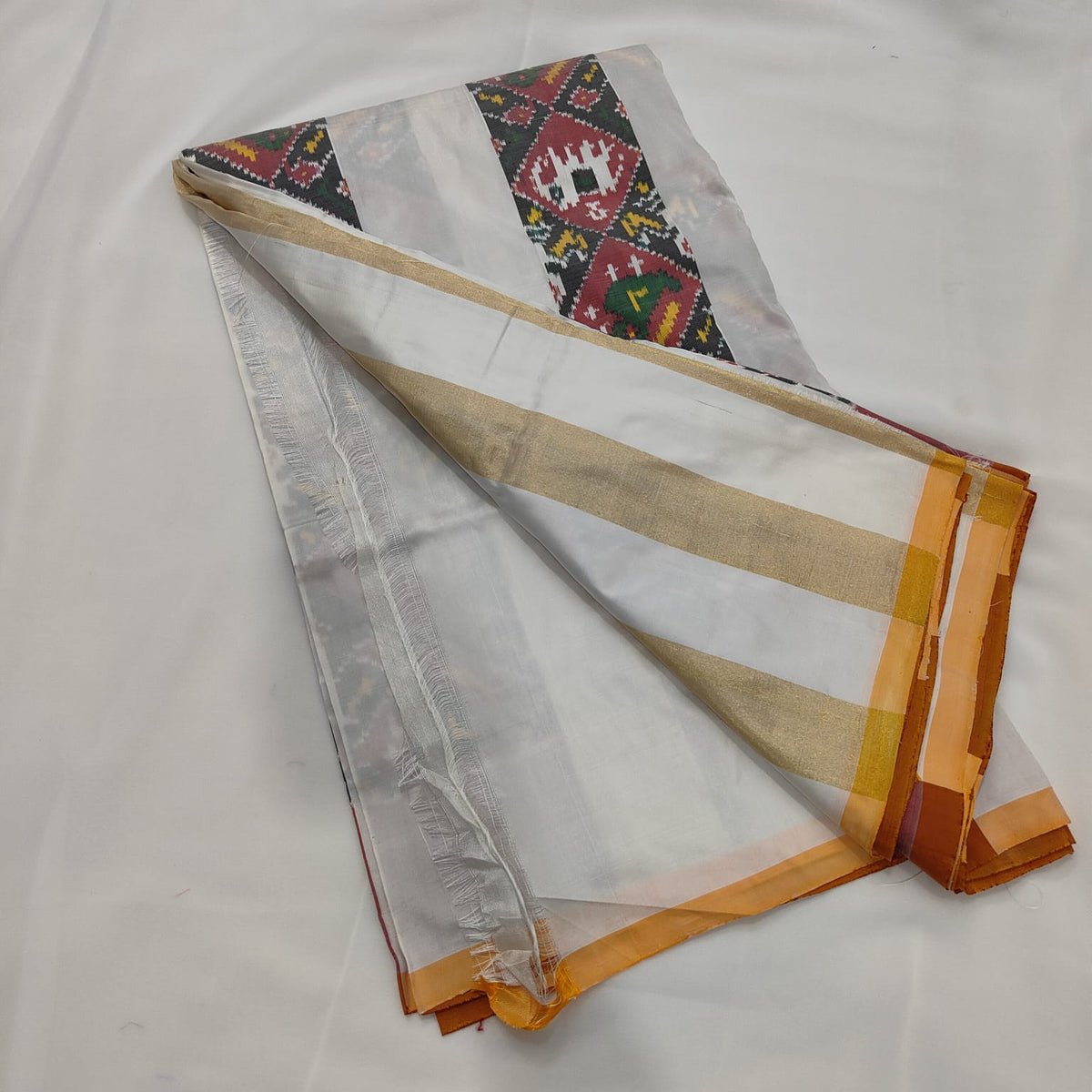 Ivory ikat silk saree, diamond panel and mustard border detail