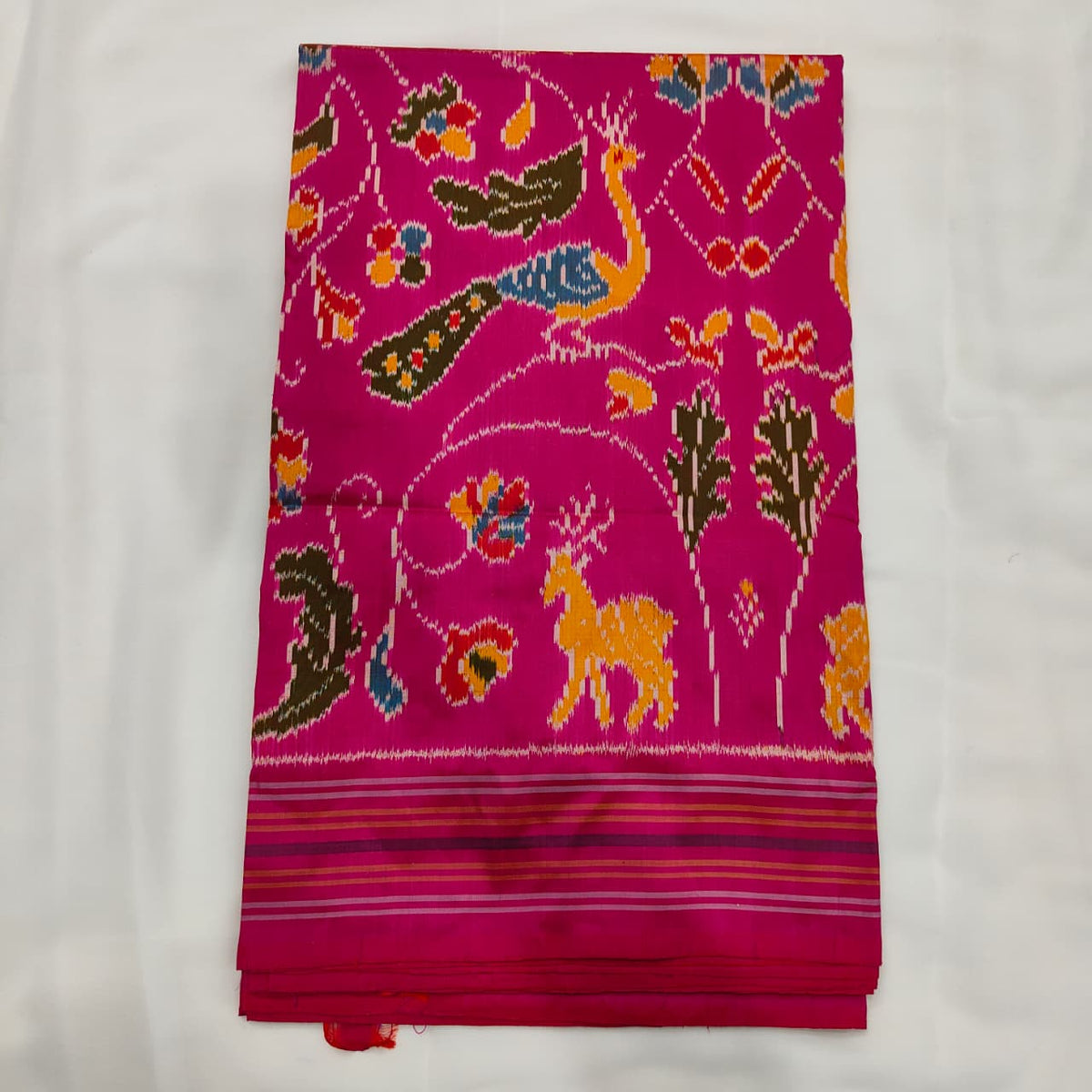 Magenta pink ikat silk saree with deer, peacock and parrot motifs