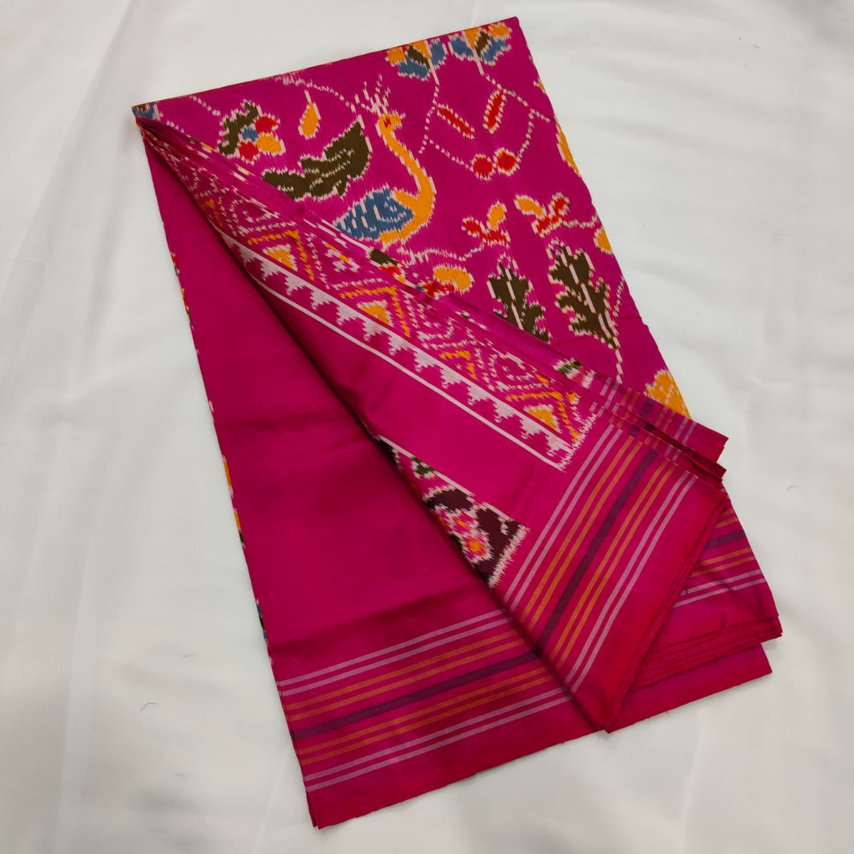Magenta pink ikat silk saree, animal motif and striped border detail