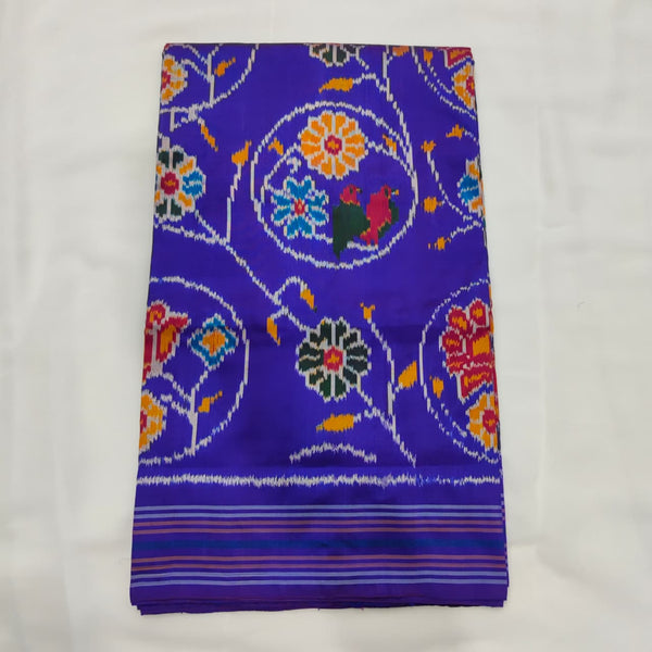 Violet blue ikat silk saree with large floral rosettes and parrot motifs